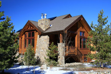 Large mountain style brown split-level wood gable roof photo in Denver