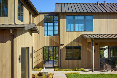 Photo of a large and brown rural two floor house exterior in San Francisco with wood cladding and a pitched roof.