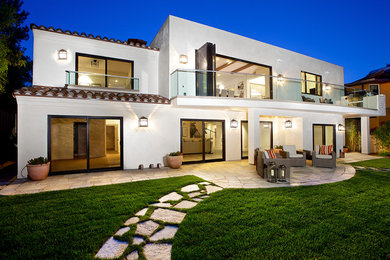 Inspiration for a white and large mediterranean two floor render house exterior in Houston with a flat roof.