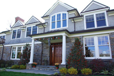 Large elegant gray two-story mixed siding exterior home photo in New York with a shingle roof