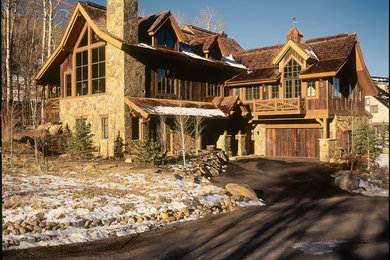 Large mountain style two-story wood gable roof photo in Denver