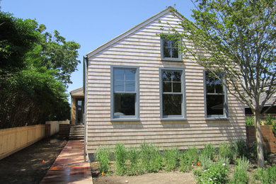 Small coastal wood exterior home idea in New York
