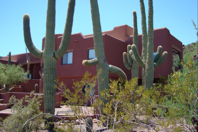 Inspiration for a large southwestern red two-story adobe exterior home remodel in Phoenix