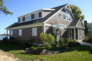 Inspiration for a mid-sized coastal brown two-story wood exterior home remodel in Cleveland with a shingle roof