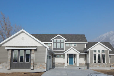 Example of a mid-sized arts and crafts gray two-story concrete fiberboard gable roof design in Salt Lake City