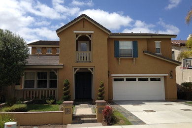 Example of a mid-sized transitional white two-story stucco gable roof design in San Diego