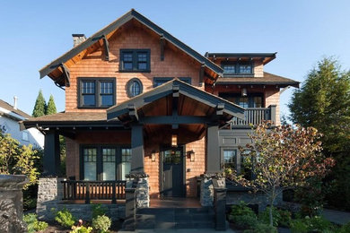 Large arts and crafts brown two-story exterior home photo in Vancouver