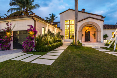 Photo of a white mediterranean two floor detached house in Miami.