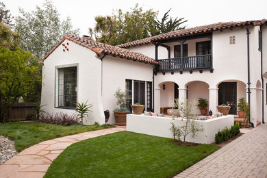 Inspiration for a mid-sized timeless white two-story stucco exterior home remodel in San Francisco with a tile roof
