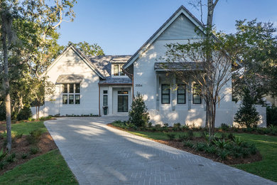 Example of a transitional gray two-story brick exterior home design in Miami with a tile roof