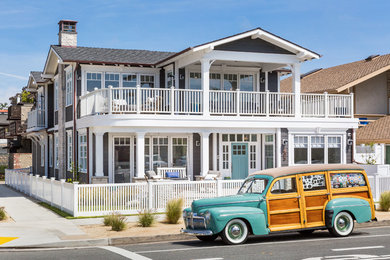 Example of a large beach style gray two-story concrete fiberboard exterior home design in San Diego with a shingle roof