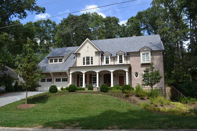 Example of a large classic two-story mixed siding house exterior design in Atlanta with a hip roof and a shingle roof