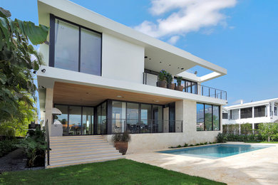 Inspiration for a large modern white two-story stucco exterior home remodel in Miami