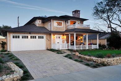 Large arts and crafts beige two-story wood house exterior photo in Santa Barbara with a hip roof and a shingle roof