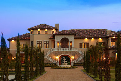 Example of a huge tuscan beige three-story mixed siding exterior home design in Miami