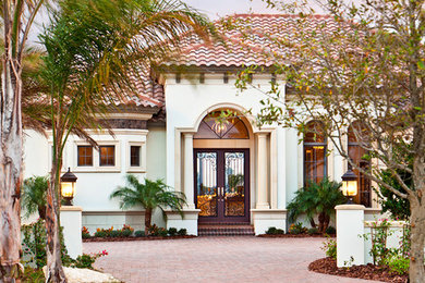 Large and white mediterranean two floor render house exterior in Tampa.