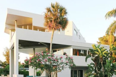 Large modern white three-story concrete flat roof idea in Tampa
