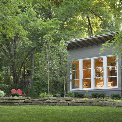 Small contemporary one-story wood exterior home idea in Kansas City with a shed roof