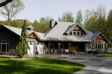 Rustic gray two-story wood house exterior idea in Grand Rapids with a hip roof and a shingle roof
