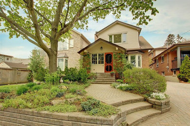 Small elegant beige two-story wood exterior home photo in Toronto with a shingle roof