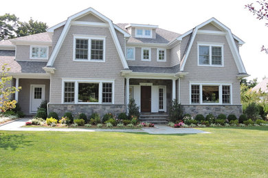 Example of a large transitional gray two-story wood exterior home design in New York with a gambrel roof