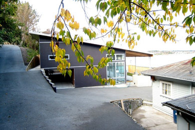 Imagen de fachada marrón moderna de tamaño medio de dos plantas con revestimiento de madera y tejado de un solo tendido