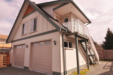 Small elegant beige concrete fiberboard exterior home photo in Vancouver