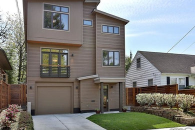 Example of a trendy beige three-story wood exterior home design in Portland