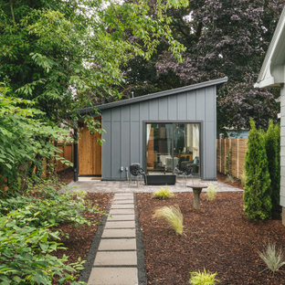 Inspiration for a small modern gray one-story wood house exterior remodel in Portland with a shed roof and a metal roof