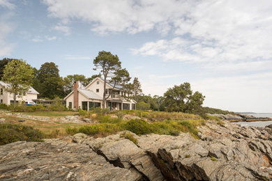 Inspiration for a timeless beige two-story wood exterior home remodel in Portland Maine with a metal roof