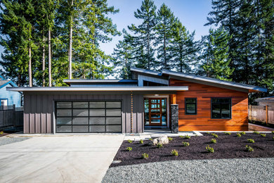 Mid-sized mountain style two-story mixed siding house exterior photo in Other with a metal roof