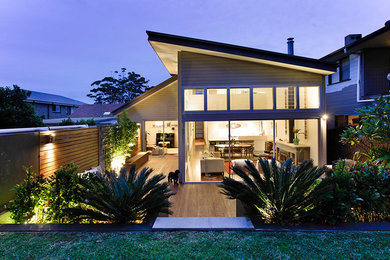 Mid-sized trendy beige two-story wood gable roof photo in Sydney