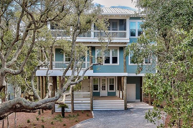 Mid-sized beach style blue three-story exterior home photo in Miami
