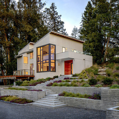 Inspiration for a mid-sized contemporary gray two-story concrete fiberboard house exterior remodel in San Francisco with a shed roof and a shingle roof
