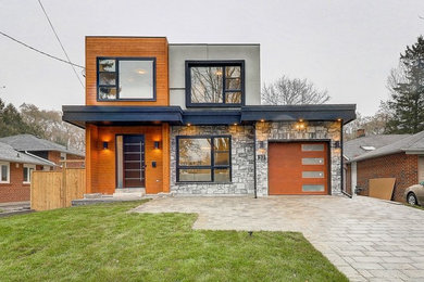 Example of a mid-sized trendy gray two-story mixed siding exterior home design in Toronto with a shingle roof