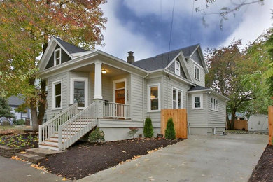 Mid-sized elegant green two-story concrete fiberboard exterior home photo in Portland with a shingle roof