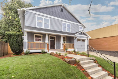 Large arts and crafts gray two-story concrete fiberboard exterior home photo in Portland with a shingle roof