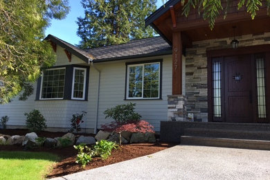 Example of a mid-sized classic gray one-story wood exterior home design in Seattle with a shingle roof