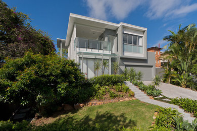 Photo of a large and gey modern two floor brick house exterior in Brisbane with a flat roof.
