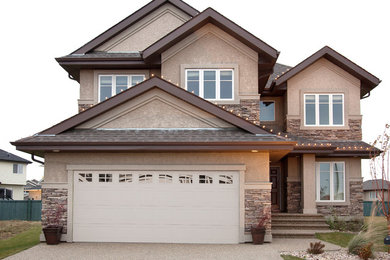 Inspiration for a timeless two-story stucco exterior home remodel in Edmonton