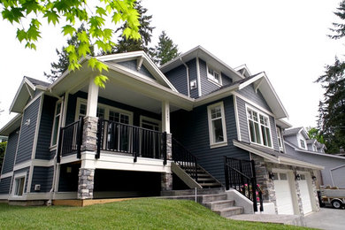 Large elegant blue three-story concrete fiberboard exterior home photo in Vancouver with a shingle roof