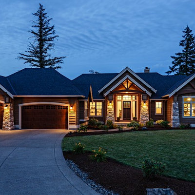Example of a mid-sized arts and crafts brown one-story mixed siding gable roof design in Portland