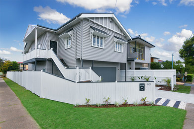Large and gey classic two floor house exterior in Brisbane with wood cladding.