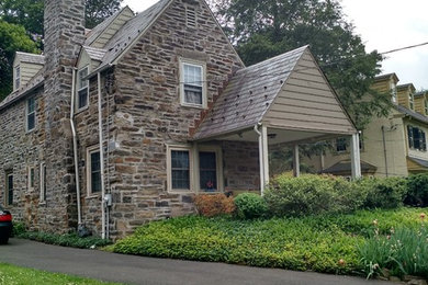 Elegant brown two-story stone exterior home photo in Philadelphia