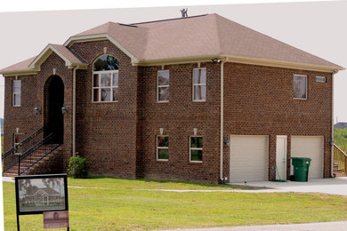 Inspiration for a mid-sized timeless brown two-story brick exterior home remodel in Birmingham with a hip roof