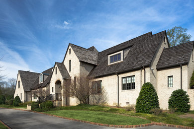 Large transitional beige two-story gable roof idea in Birmingham