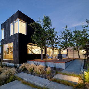 Large minimalist black two-story wood exterior home photo in San Francisco with a shed roof