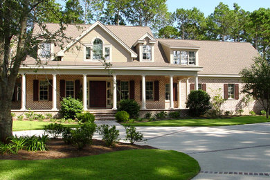 Large elegant red two-story mixed siding gable roof photo in Atlanta
