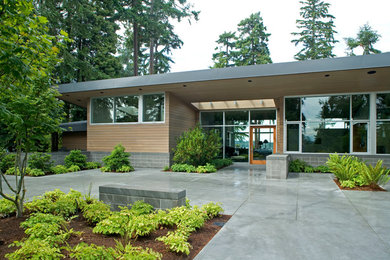 Example of a mid-sized trendy multicolored one-story mixed siding house exterior design in Seattle with a hip roof
