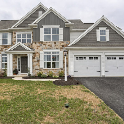 Example of a large classic gray two-story vinyl gable roof design in Other